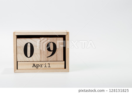 Wooden calendar April 09 on a white background 128131825
