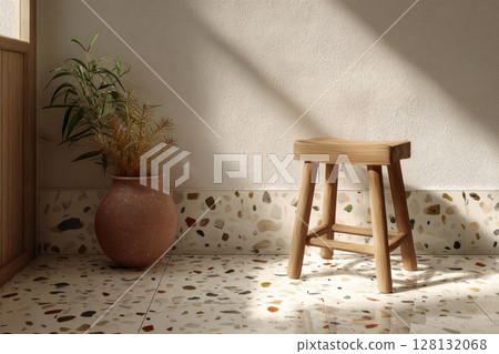 Bathroom corner featuring terrazzo tiles, wooden stool, and vase with plants against textured wall 128132068