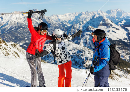 Three young adult happy friends candid portrait enjoy have fun skiing enjoy winter extreme sport activities on sunny day. People winter sport active holidays. Healthy people lifestyle Three young adult happy friends candid portrait enjoy have fun skiing enjoy winter extreme sport activities on sunny day. People winter sport active holidays. Healthy people lifestyle 128133576