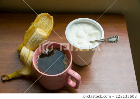 good morning : HEALTHY BREAKFAST - Yogurt with cupronickel spoon , coffee and banana  128133608