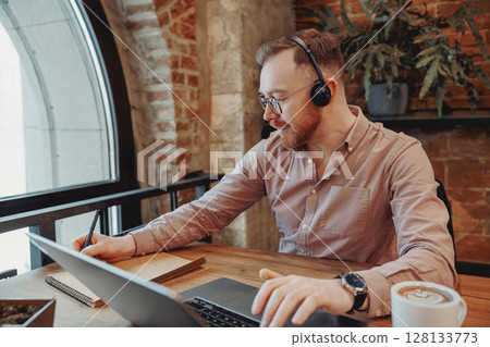 Focused Professional Working Remotely in a Cozy Caf 128133773