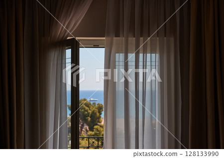 Apartment with sea view, open balcony door 128133990