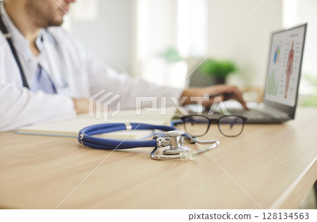 Stethoscope medical instrument close up, professional doctor physician or cardiologist at desk Stethoscope medical instrument close up, professional doctor physician or cardiologist at desk 128134563