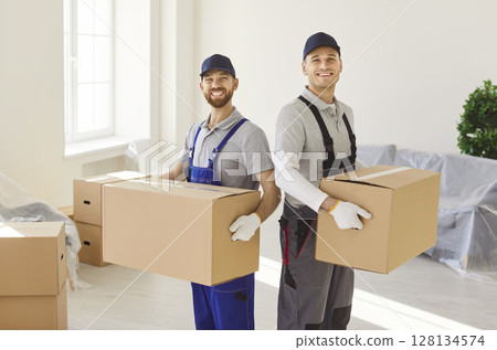 Delivery service for transporting men carrying cardboard boxes, movers service unloading removing 128134574