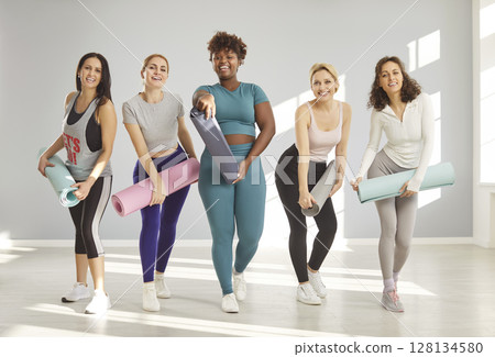 Five sporty mixed race women meet together for having yoga class 128134580