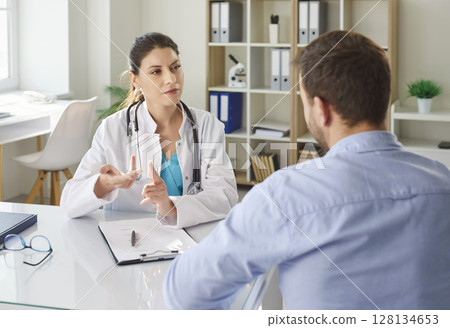 Doctor Consulting Male Patient In Hospital 128134653