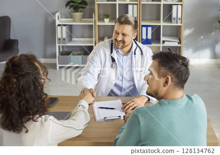Doctor meeting, congratulate consulting happy couple patients in fertility clinic, offering help 128134762
