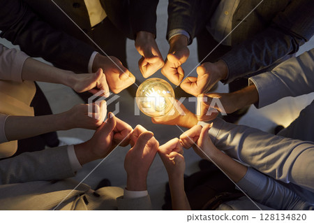 Business people holding lightbulb joining hands in a circle sharing creative and innovative ideas. Business people holding lightbulb joining hands in a circle sharing creative and innovative ideas. 128134820