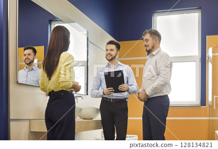 Consultant Assisting Couple In Plumbing Shop For Sink Consultant Assisting Couple In Plumbing Shop For Sink 128134821