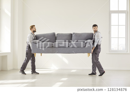 Two trained furniture movers team, delivering sofa, upholstery, repair services advertisement Two trained furniture movers team, delivering sofa, upholstery, repair services advertisement 128134876
