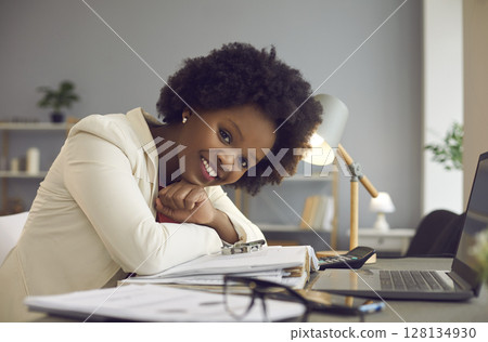 Happy smiling casual black woman office worker take rest at desk with laptop 128134930