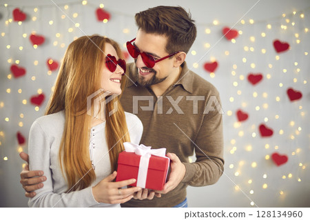 Happy couple celebrating Valentine's Day at home and enjoying spending time together. Happy couple celebrating Valentine's Day at home and enjoying spending time together. 128134960