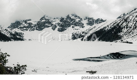 Frozen Lake Morskie Oko or Sea Eye Lake in Poland at Winter. Panoramic view Frozen Lake Morskie Oko or Sea Eye Lake in Poland at Winter. Panoramic view 128134971
