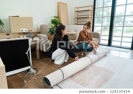 Lesbian Couple Moving into New Home - LGBT Family Unpacking and Decorating Modern House Together Lesbian Couple Moving into New Home - LGBT Family Unpacking and Decorating Modern House Together 128135454