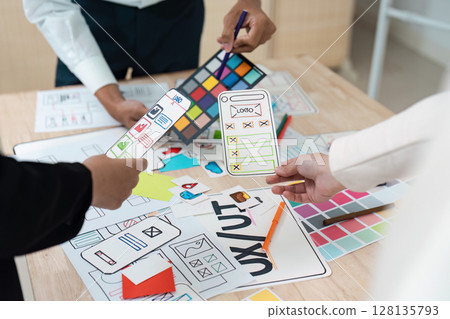 Creative Team collaboration on UX UI Design Concepts with Wireframes and Color Palettes for Mobile Application Development 128135793