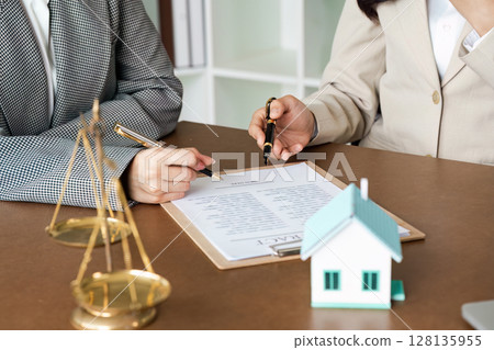 Professional Legal Consultation with Lawyers Reviewing Contract Documents and Scales of Justice on Desk Professional Legal Consultation with Lawyers Reviewing Contract Documents and Scales of Justice on Desk 128135955