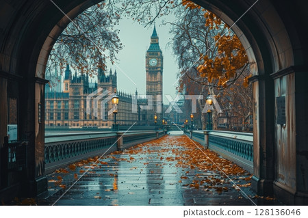 A man walks down a street in London at night 128136046