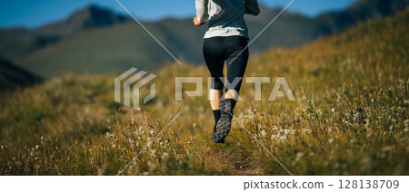 Fitness woman runner running in grassland Fitness woman runner running in grassland 128138709