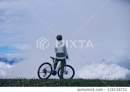 Asian woman riding mountain bike on beautiful mountain top 128138732