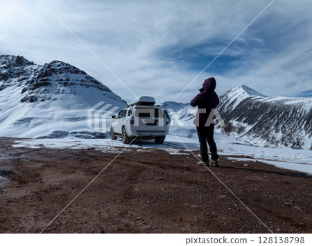 Woman photographer remote control a drone on high altitude mountain top, China 128138798