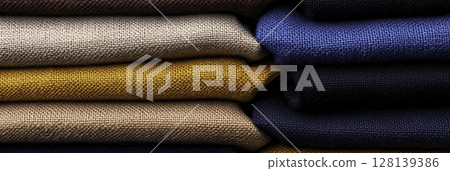 Textured Fabrics Piled Neatly in Various Colors Displaying Softness and Richness Textured Fabrics Piled Neatly in Various Colors Displaying Softness and Richness 128139386