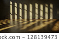 Shadows and Light Play on Wooden Floor in Minimalist Interior Space 128139473