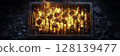 Glowing Charcoal on a Grill with Flames Rising in Dark Background 128139477