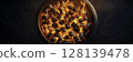 Fiery Charcoal in a Grill with Glowing Embers and Smoke Rising in Darkness 128139478