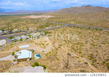 Fountain Hills, Arizona showing desert terrain with scattered residential properties Sonoran Desert environment with sparse vegetation and developed areas integrated desert landscape. 128139851