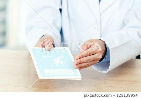 A female pharmacist handing over a prescription A female pharmacist handing over a prescription 128139954