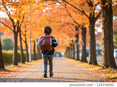 Children walking to school along a tree-lined street in autumn 128140002