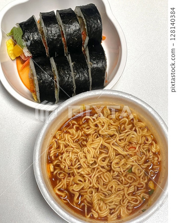Kimbap and Ramyun, a perfect Korean combo! Enjoy savory rice rolls with vegetables, meat, and pickles alongside a flavorful bowl of spicy, comforting ramen. A satisfying meal for any time of day. Kimbap and Ramyun, a perfect Korean combo! Enjoy savory rice rolls with vegetables, meat, and pickles alongside a flavorful bowl of spicy, comforting ramen. A satisfying meal for any time of day. 128140384