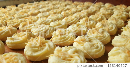 Crispy and melt-in-your-mouth sagu keju cookies made from sago flour and topped with cheese. This delightful Indonesian snack is perfect for festive occasions or a light treat. 128140527