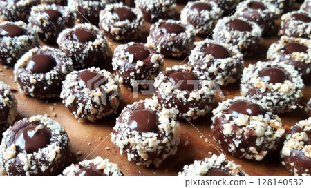 Buttery chocolate thumbprint cookies with a rich cocoa flavor, filled with smooth chocolate ganache or creamy filling. A delightful treat for chocolate lovers and special occasions. 128140532
