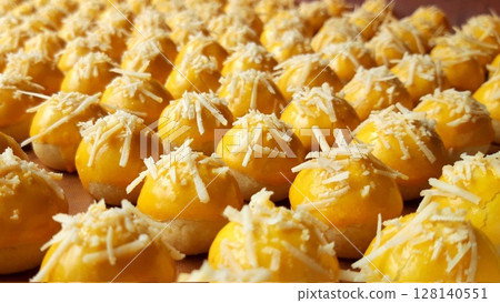 Soft and buttery nastar keju cookies filled with sweet pineapple jam, topped with grated cheese. A perfect blend of sweetness and savory, ideal for festive moments or as a snack. Soft and buttery nastar keju cookies filled with sweet pineapple jam, topped with grated cheese. A perfect blend of sweetness and savory, ideal for festive moments or as a snack. 128140551