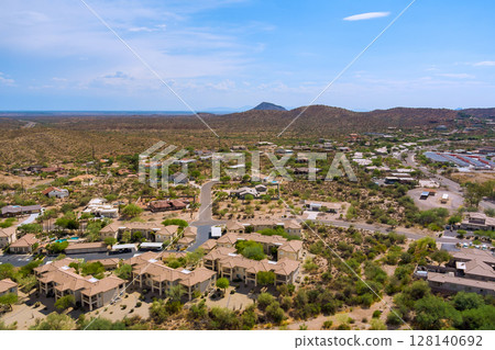 Mirage Cove Condominiums in Fountain Hills, Arizona residential development features tan colored buildings with parking areas surrounding Sonoran desert landscape 128140692