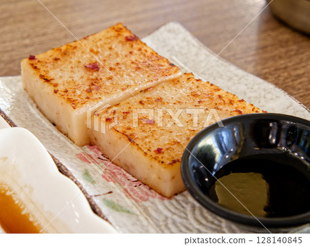 Pan-Fried Turnip Cake. Crispy edge, soft savory radish cubes 128140845