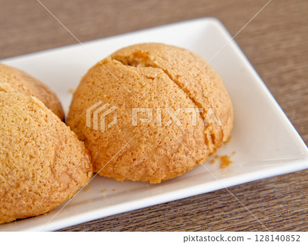 Cantonese Flaky Crust Char Siu Bun, Buttery crust, tender barbecued pork inside Cantonese Flaky Crust Char Siu Bun, Buttery crust, tender barbecued pork inside 128140852