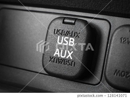 Closeup of car USB port and AUX input. Automotive connectivity in-car audio and charging. 128141071