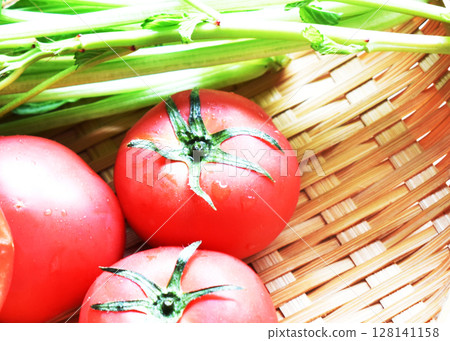 Close-up of fruit tomatoes and spinach in a colander Close-up of fruit tomatoes and spinach in a colander 128141158