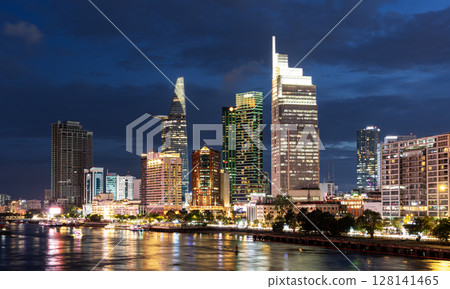 Ho Chi Minh City, Vietnam June 23, 2025: Sunset at district 1, view to Bitexco Financial Tower with Vietnam flag on the top building. One of the famous buildings in ho chi minh city view point. Ho Chi Minh City, Vietnam June 23, 2025: Sunset at district 1, view to Bitexco Financial Tower with Vietnam flag on the top building. One of the famous buildings in ho chi minh city view point. 128141465