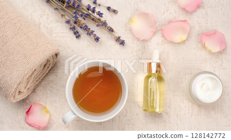 a cup of hot tea with rose petals 128142772