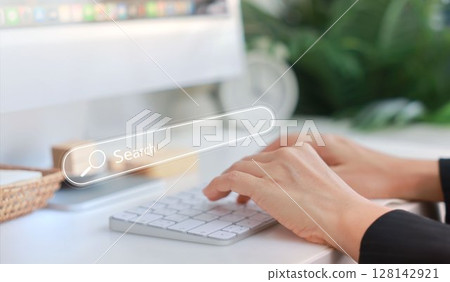 Hands typing on a white keyboard with search bar overlay, representing internet browsing, SEO, online research, digital marketing, communication, data input, coding and information search concept. 128142921