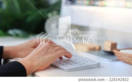 Hands typing on a white keyboard with search bar overlay, representing internet browsing, SEO, online research, digital marketing, communication, data input, coding and information search concept. Hands typing on a white keyboard with search bar overlay, representing internet browsing, SEO, online research, digital marketing, communication, data input, coding and information search concept. 128142922