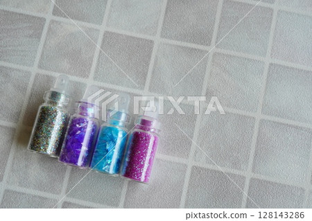 Sparkling decoration materials set of transparent vials containing four colors of glitter 128143286