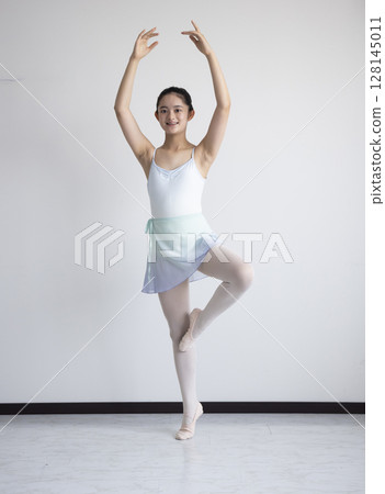 Cute woman learning ballet 128145011