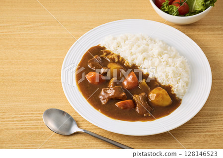 Delicious curry rice served on a plate 128146523