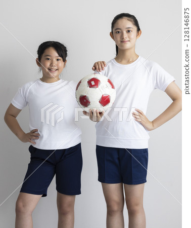 Elementary school girl with a soccer ball Elementary school girl with a soccer ball 128146875