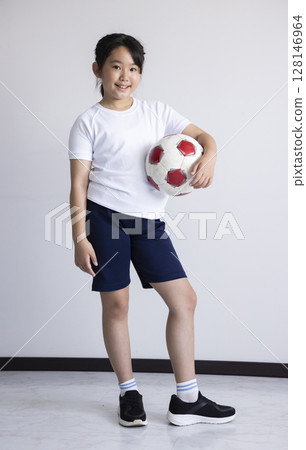 Elementary school girl with a soccer ball Elementary school girl with a soccer ball 128146964