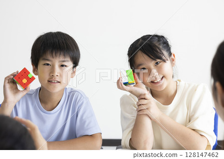 Elementary school student playing Rubik's Cube 128147462